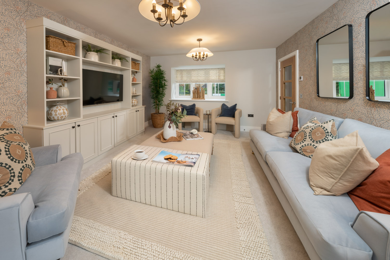 Living room with grey sofa, cream carpet and wall recess tv