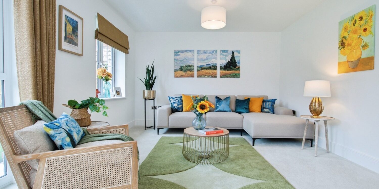 Living room with sofa and rug and chair and pictures hanging on the wall in the background